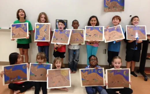 a group of children holding up posters
