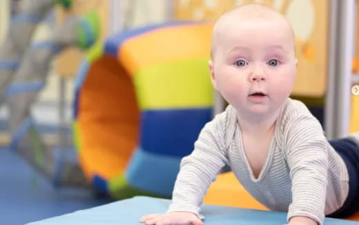 a baby sitting at a table