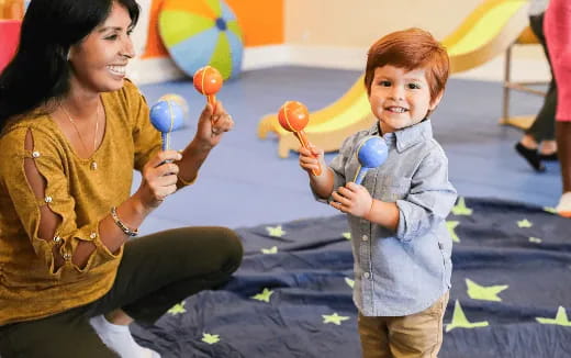 a person and a child holding balloons