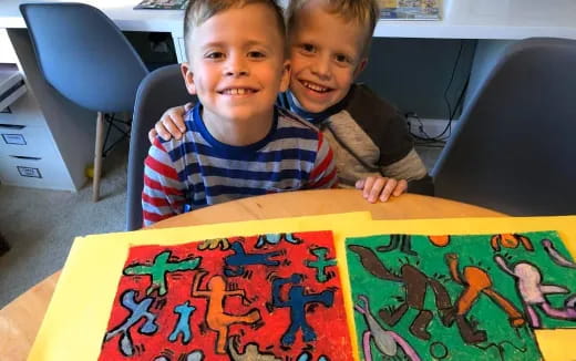 two boys sitting at a table