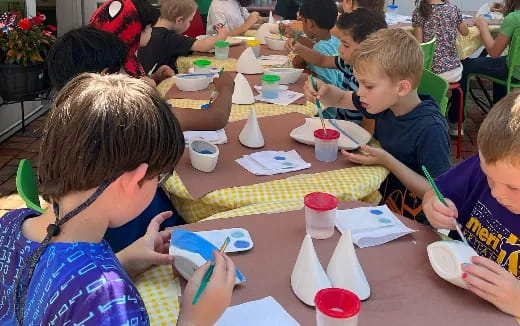a group of children eating at a table