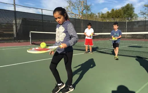 a person hitting a ball with a tennis racket