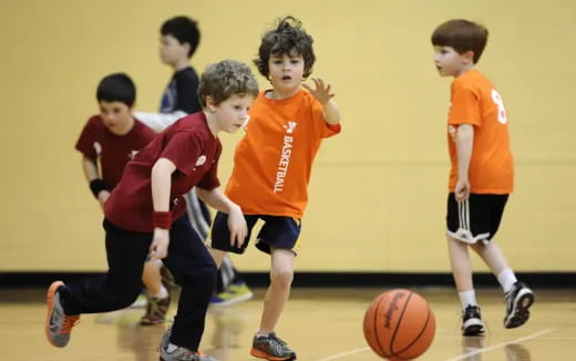 a group of kids playing basketball