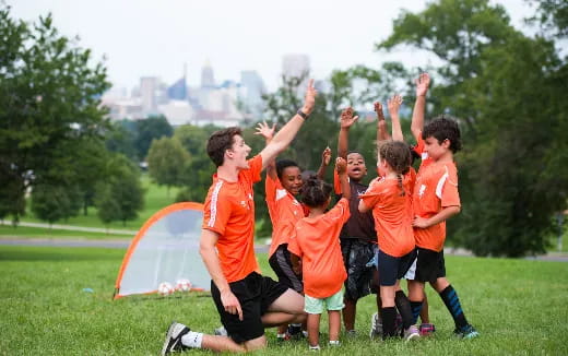 a group of boys in orange shirts