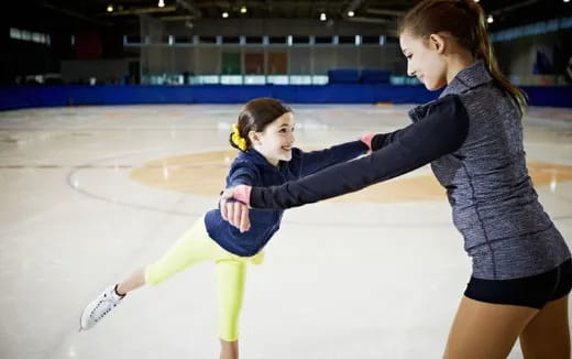 a couple of women on an ice rink