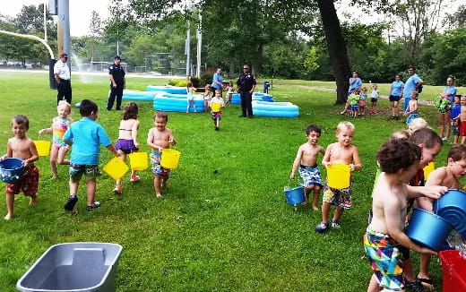 a group of children playing in a grassy area