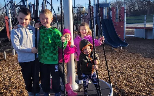 a group of children playing on a playground