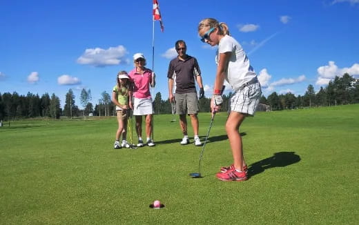 a group of people playing golf