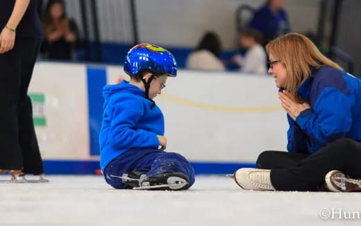 a person and a boy on ice