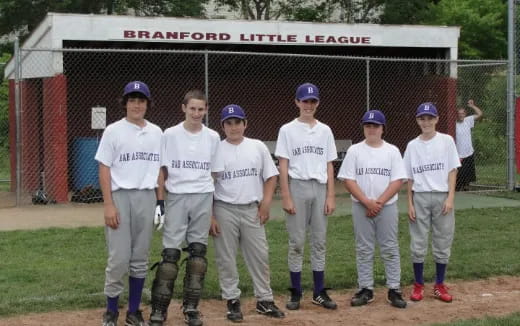 a group of kids in white uniforms