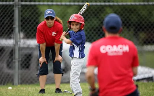 a group of kids playing baseball