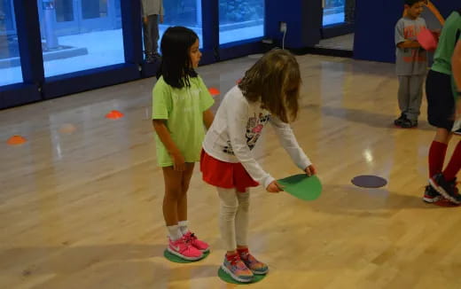 a group of children playing with a frisbee