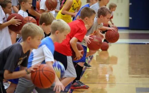 a group of kids playing basketball