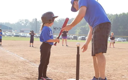 a man and a child playing baseball
