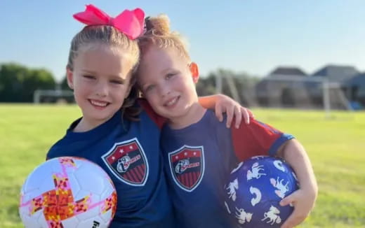 a couple of girls holding a ball