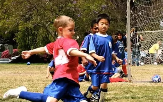 a group of kids playing football