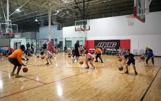a group of people playing basketball