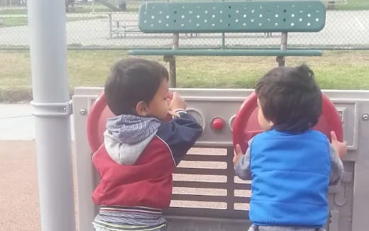 a group of kids sitting on a bench