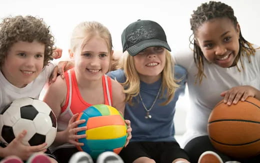 a group of kids holding basketballs