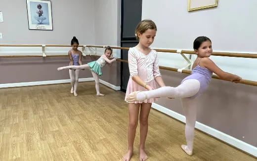 a group of girls practicing ballet