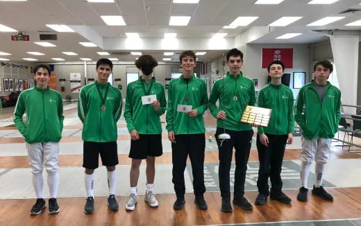 a group of people in green shirts