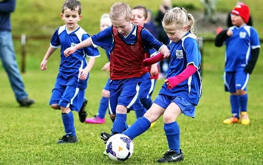 kids playing football on a field