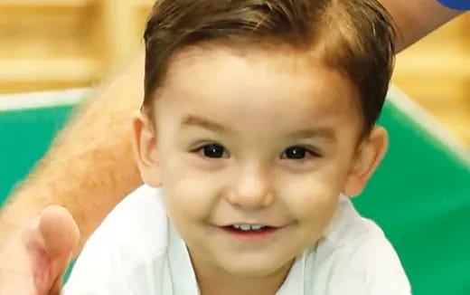 a baby with a hand on its head