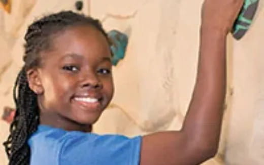 a girl smiling with her arm up