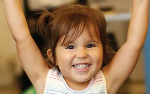 a girl with her hands on her head