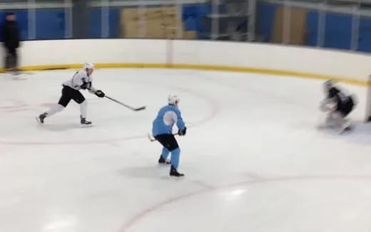 a group of people playing hockey