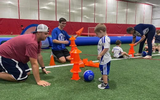 a person and a boy playing football