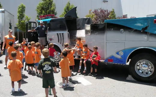 a group of children in orange uniforms