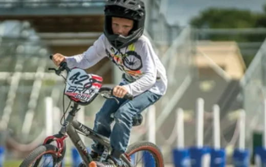 a young boy riding a bicycle