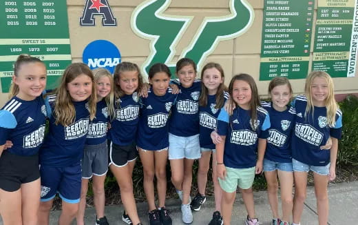 a group of girls in blue shirts