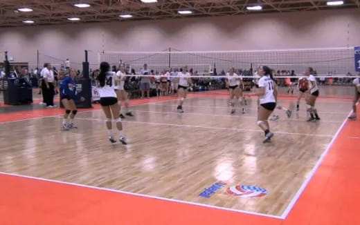 a group of people playing volleyball