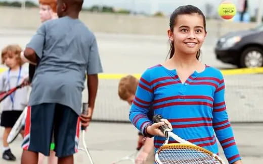 a girl holding a tennis racket