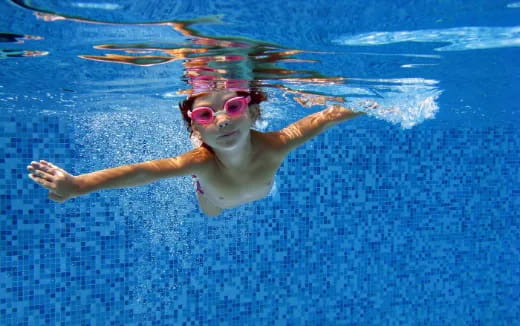 a woman swimming in a pool