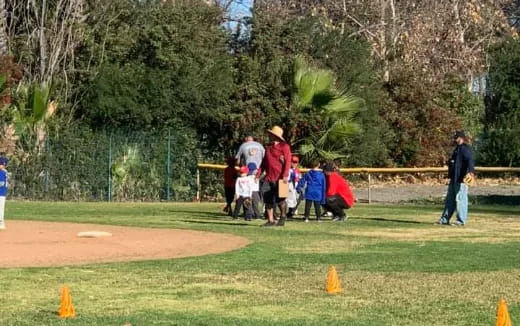a group of people playing baseball