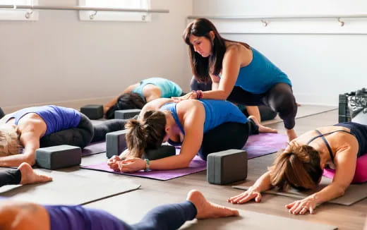a group of women doing yoga