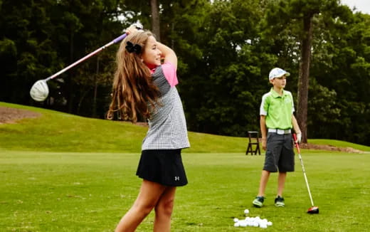 a person swinging a golf club