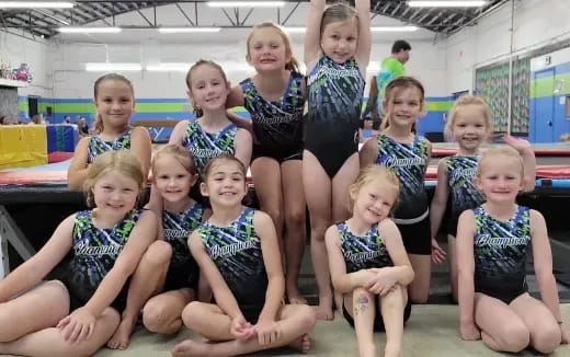 a group of girls in swimsuits posing for a photo
