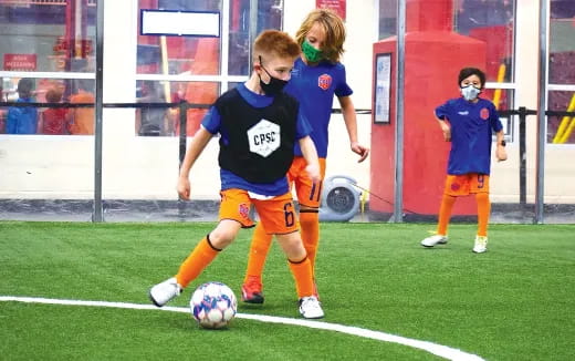 kids playing football on a field