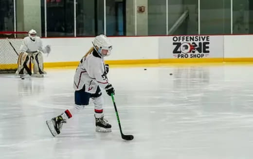 a person wearing a helmet and holding a hockey stick