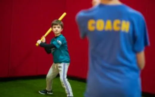 a boy holding a baseball bat