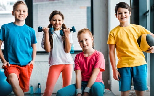 a group of kids holding exercise equipment