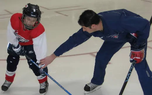 a couple of men playing hockey