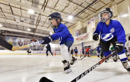 a couple of men playing hockey