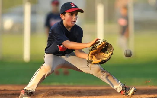 a baseball player catching a baseball