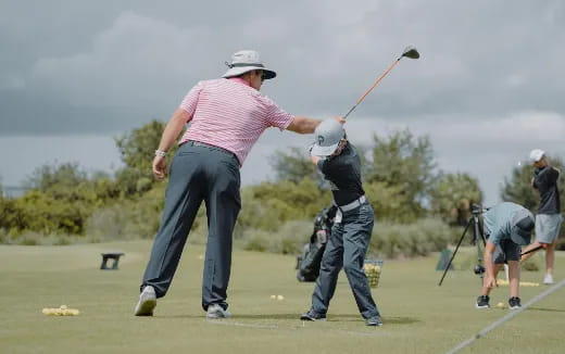 a man swinging a golf club