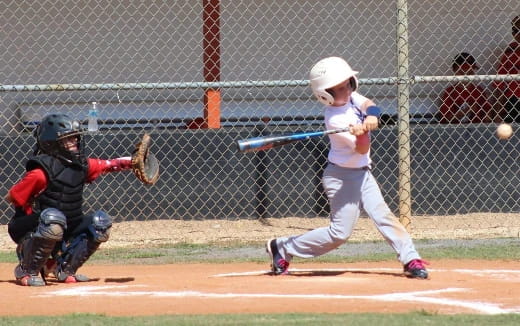 a kid swinging a baseball bat
